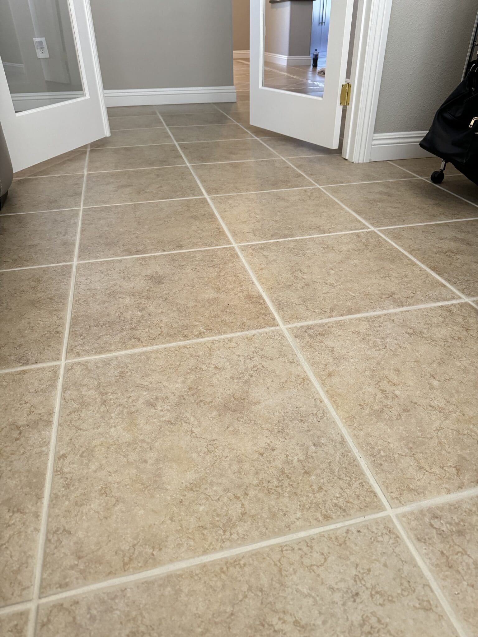 Clean ceramic tile floor with light grout lines in a Las Vegas home after professional tile and grout cleaning
